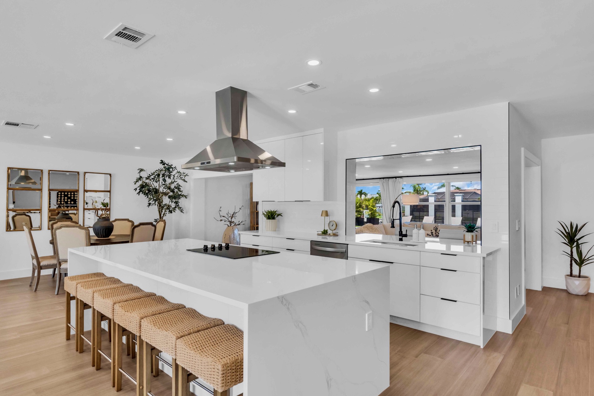Chef's kitchen with waterfall quartz island and bar seating for 8