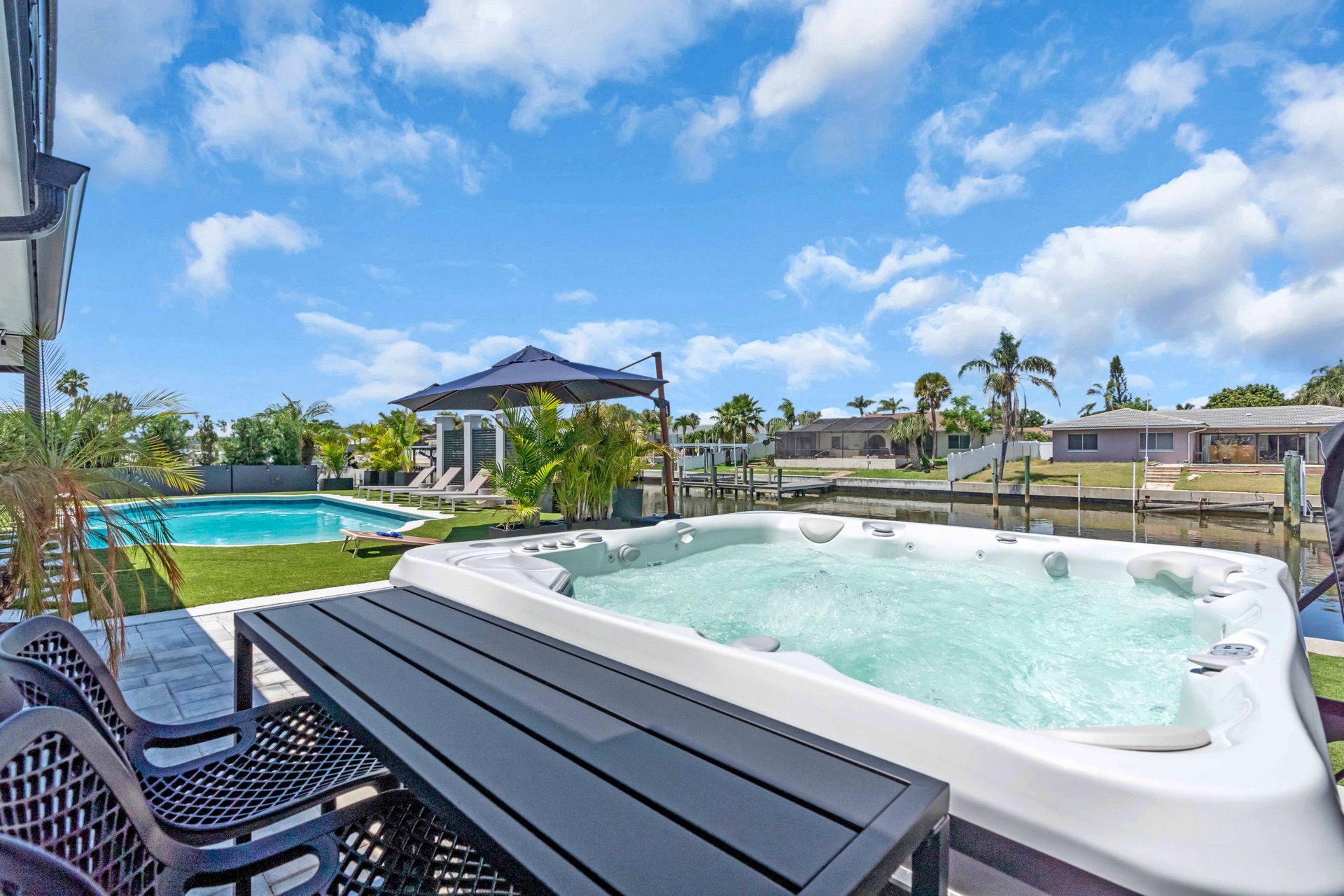 7-person massaging hot tub overlooking Tampa Bay canal at waterfront vacation rental